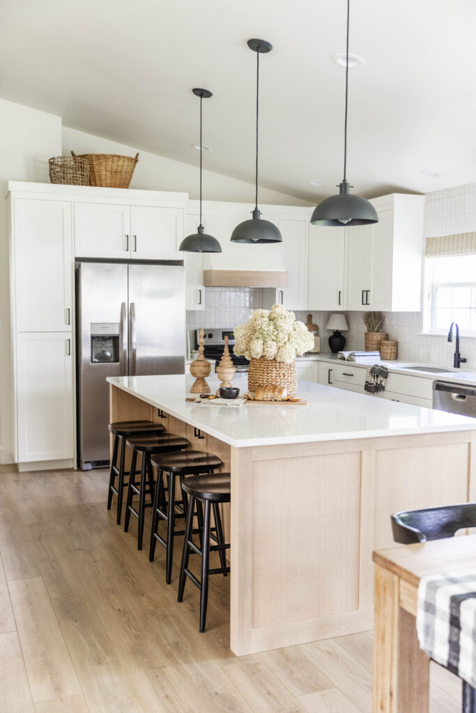 four Black Backless Counter Stools at the kitchen island in a designer home in Twin Falls, Idaho