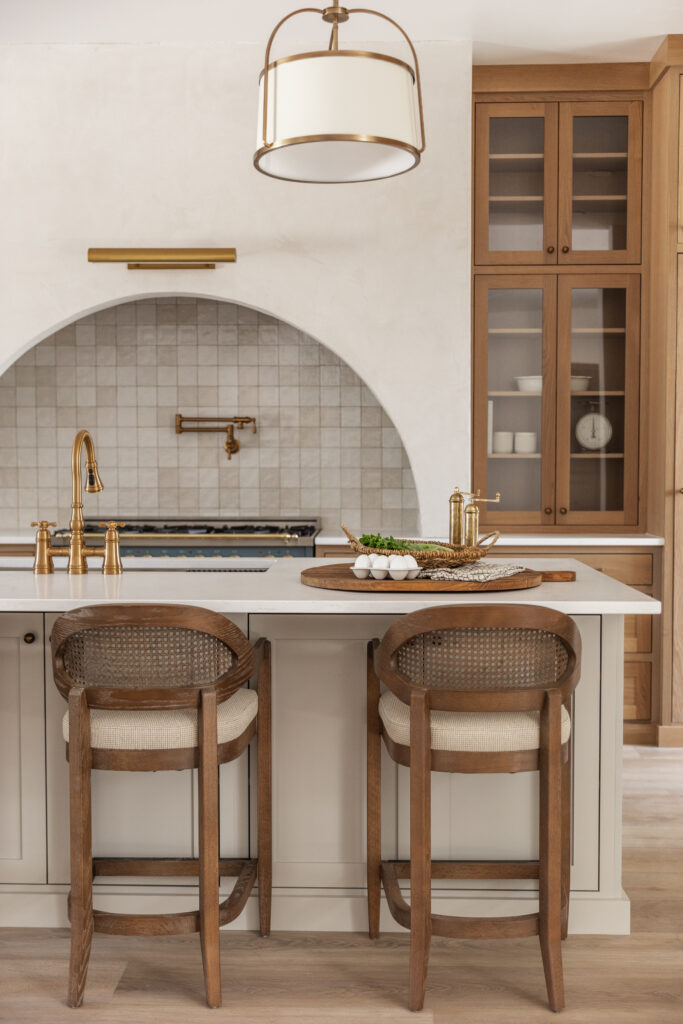 a photo of 2 Americana Modern Cane Back Counter Stools at the island in a custom kitchen | Meg & Co