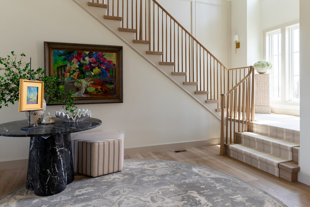 a beautiful shot of an entryway to the Magic Valley parade home by Meg & co., the walls are painted in one of the best interior paint colors called Swiss Coffee by Benjamin Moore.