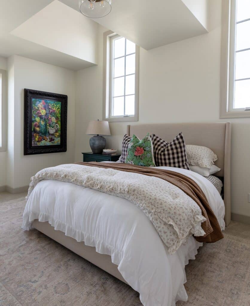 a large oil painting is displayed on the left side of the queen bed in a custom bedroom created by Meg & Co in Twin Falls Idaho