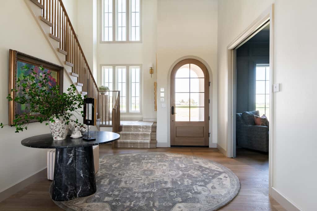 a photo of an entryway with a perfectly placed art by the table at the Charles custom home that was featured on Magic Valley Parade of homes by Meg & co 