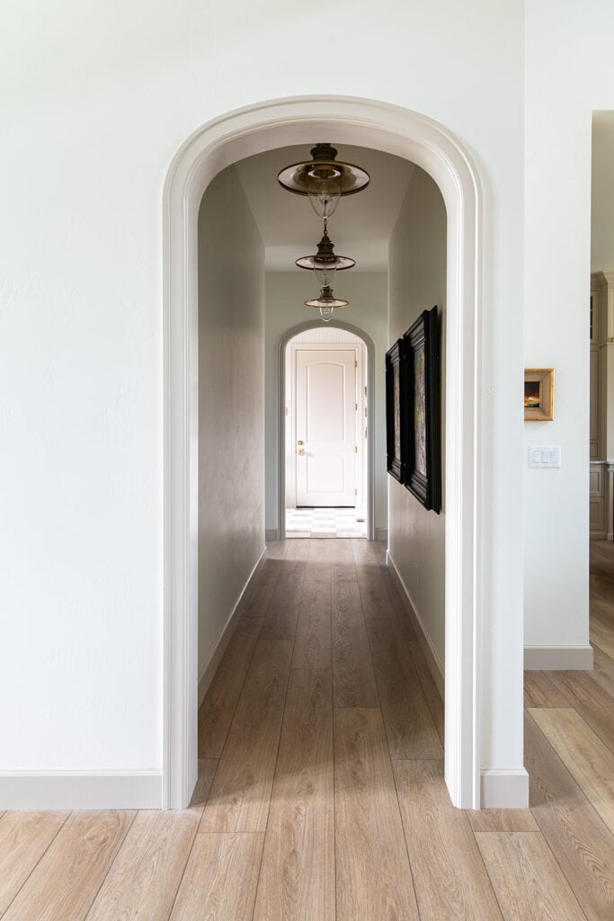 a row of three Victoria Station Lights in a hallway in a custom home by Meg & Co 