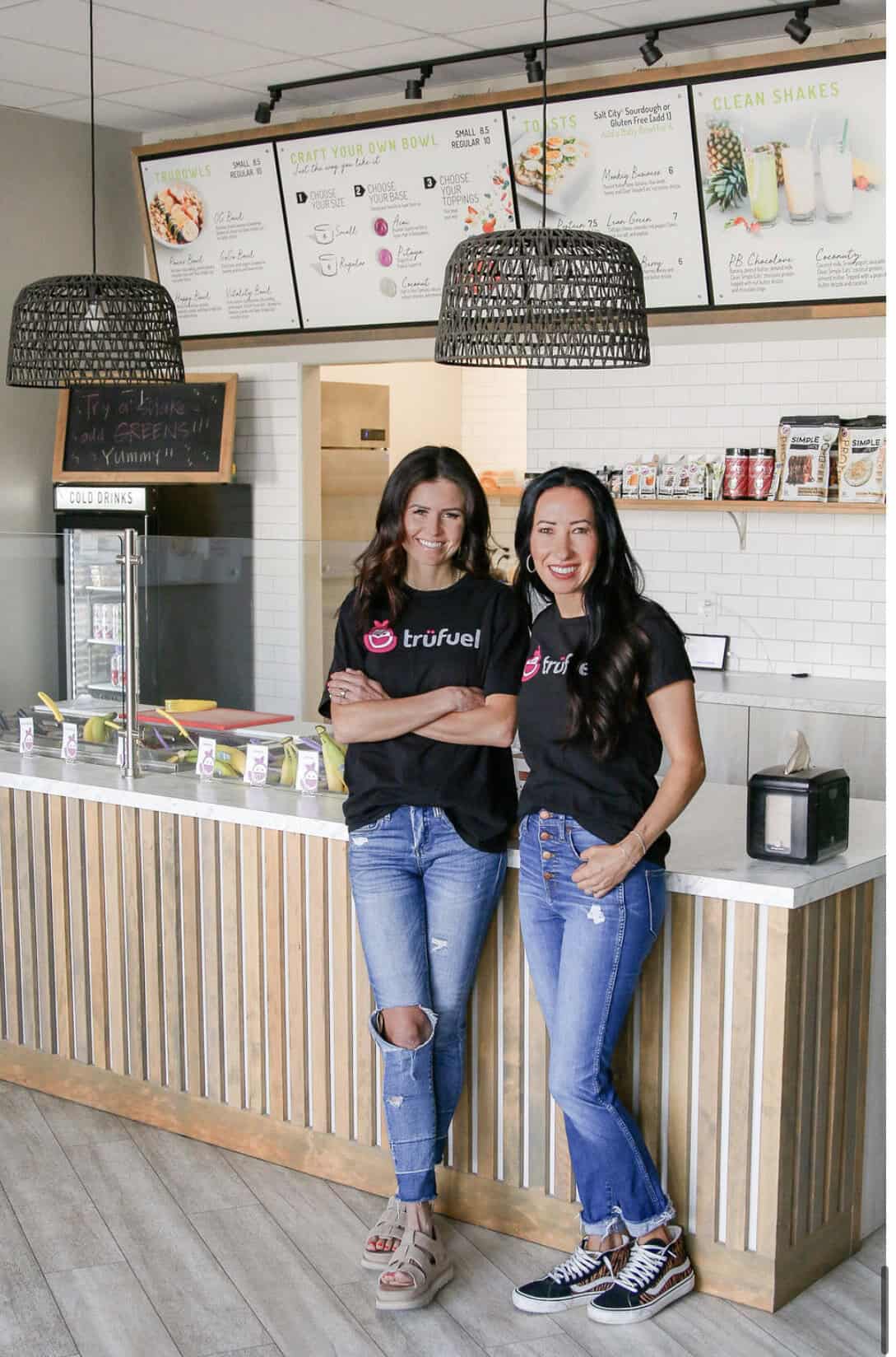 a photo of Nicole and Chelsie in front of the counter at the cafe that they founded together - TrüFuel Café is located at 1520 Fillmore St., Suite 2 in Twin Falls