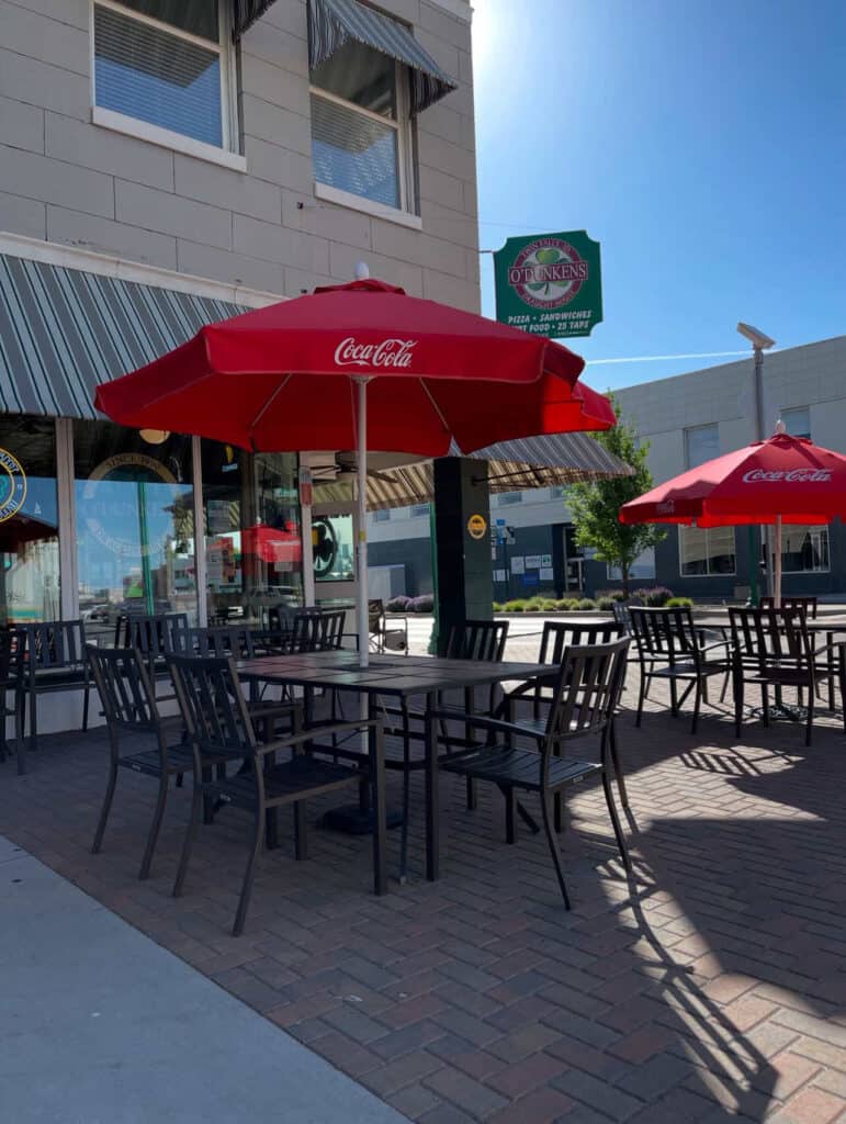 Outdoor patio seating with black tables and chairs at the O’Dunken’s: a great business downtown Twin Falls