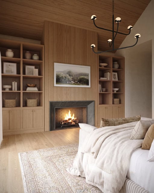 Primary Bedroom - Custom Home Hailey Idaho Primary bedroom in The Merrick featuring a fireplace, custom wood built-ins, wood-paneled ceiling, and warm mountain modern finishes.