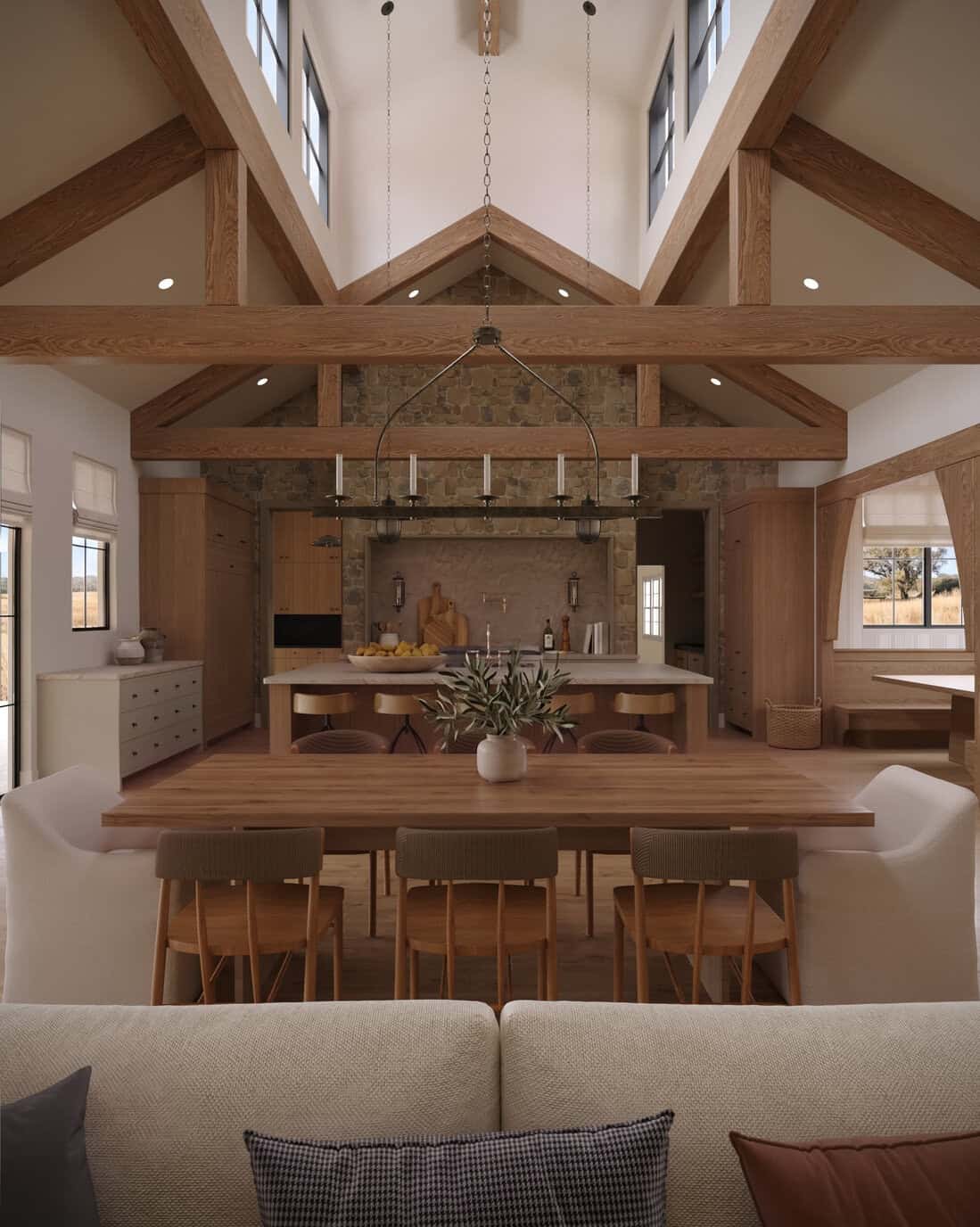 Dining room in The Merrick custom home featuring exposed timber beams, warm wood finishes, vaulted ceilings, and an open-concept layout.