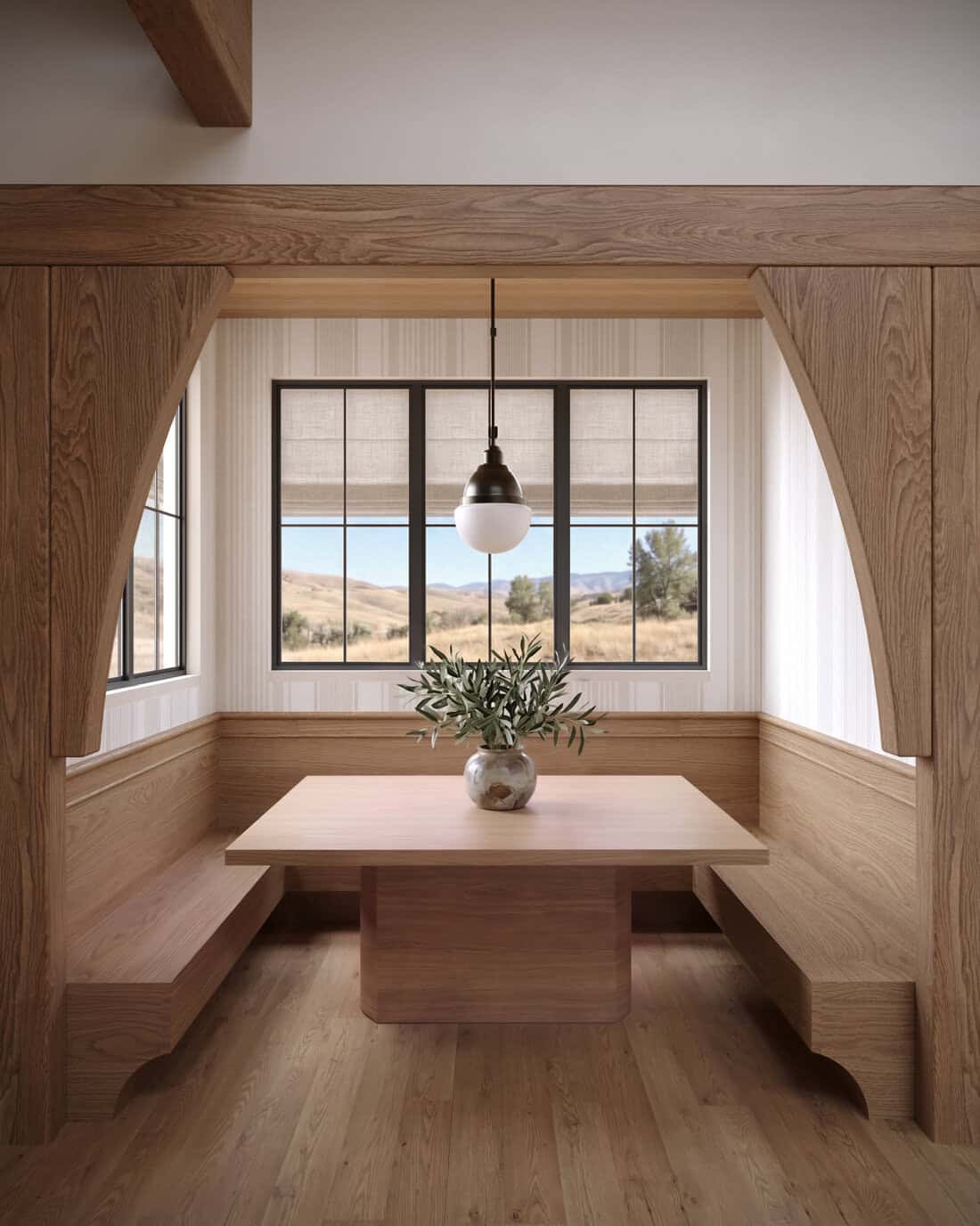 The Merrick Kitchen Nook - Luxury Custom Home Hailey Idaho Cozy kitchen dining nook in The Merrick featuring built-in wood seating, a large picture window, and warm natural finishes.