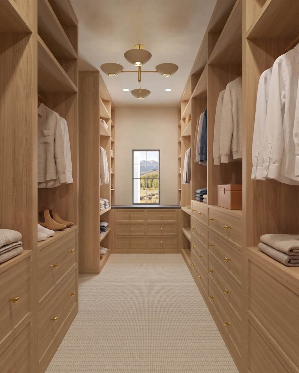 The Merrick Primary Walk-In Closet - Luxury Custom Home Hailey Idaho Custom walk-in primary closet in The Merrick featuring extensive natural wood cabinetry, built-in storage, and warm modern finishes.